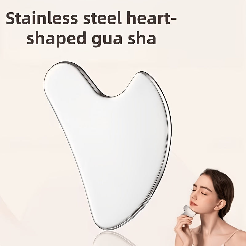 Heart-shaped stainless steel gua sha used on the jaw
